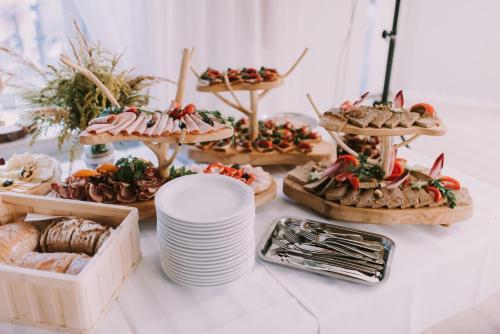 a table topped with appetizers and food on plates at Jurajska Przystań in Jastrząb