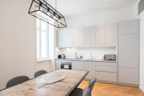 a kitchen with a table and chairs in a room at Mint@Naschmarkt Premium Apartments in Vienna