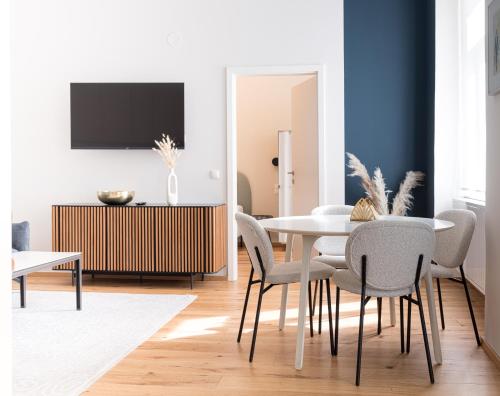 a dining room with a table and chairs at Mint@Naschmarkt Premium Apartments in Vienna