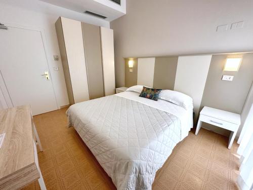 a bedroom with a large white bed in a room at Aura Living Hotel in Rimini