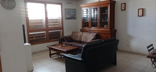 a living room with a couch and a coffee table at Le Village in Marseille