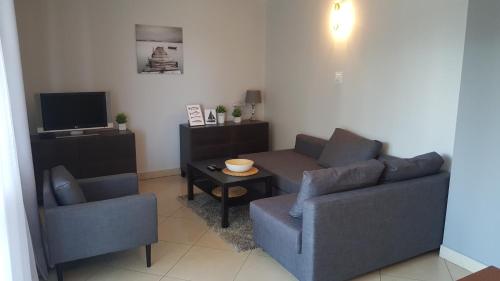 a living room with two couches and a tv at Jurajska Przystań in Jastrząb