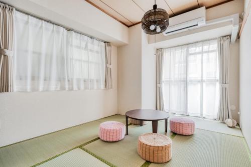 a living room with a table and two stools at Park Residence Omori in Tokyo