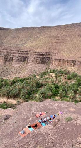 a group of people laying on top of a mountain at Ouednoujoum Ecolodge & Spa in Ouarzazate