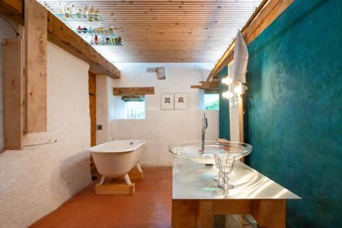 a bathroom with a sink and a bath tub at Clemens Ruben in Mont-Soleil