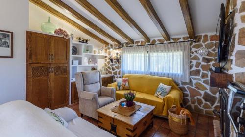 a living room with a couch and a table at Alojamiento Rural El Aguelo Belmez de la Moraleda by Ruralidays in Jaén