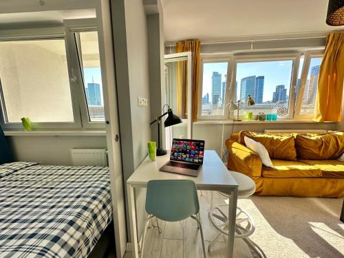 a room with a bed and a desk with a laptop on it at GOLD 2 King Size Bed, metro x2 free WiFi, 50'TV Netflix, HBO, AppleTV+ in Warsaw