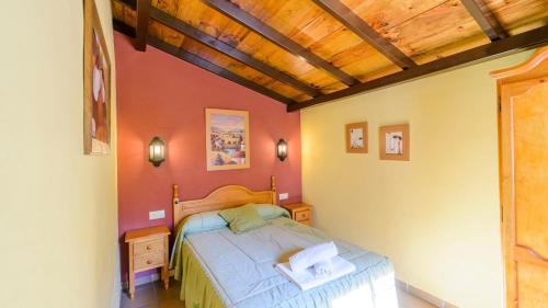 a bedroom with a bed and a wooden ceiling at El Rincón de La Iruela by Ruralidays in La Iruela