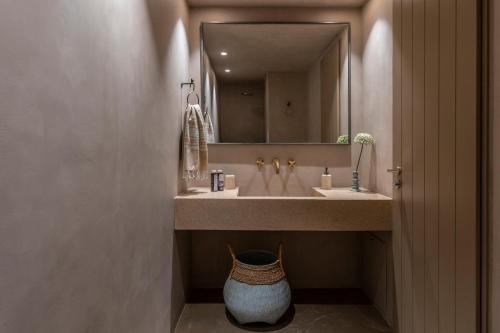a bathroom with two sinks and a large mirror at Homa Serifos pool villas in Serifos Chora