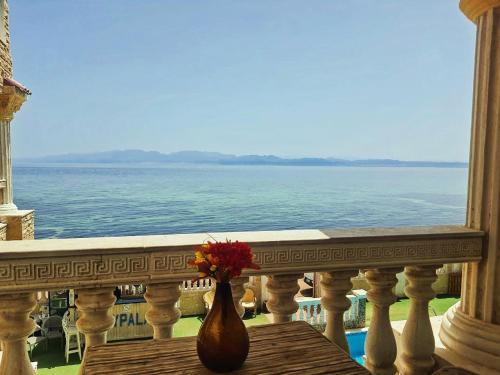 a vase with a flower in it sitting on a balcony at Lucky palace Dahab in Dahab
