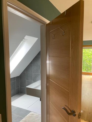 uma casa de banho com um armário e uma porta de madeira em Willow Loft 