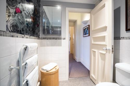 a bathroom with a toilet and a sink at West George Street Apartment in Glasgow