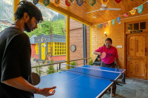 two men playing ping pong in a ping pong table at Whoopers Boutique Kasol in Kasol