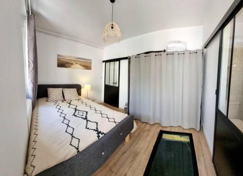 une chambre avec un grand lit et une fenêtre dans l'établissement T2 Cosy & Garden - HYPERCENTRE - GARE - WIFI, à Toulouse