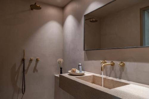 a bathroom with a sink and a mirror at Homa Serifos pool villas in Serifos Chora