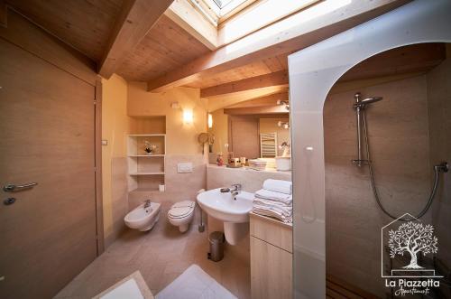 a bathroom with a sink and a toilet and a window at Appartamenti La Piazzetta in Sirmione
