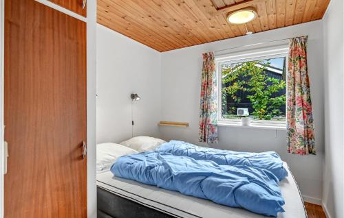 a bed in a room with a window at 2 Bedroom Nice Home In Fårvang in Fårvang