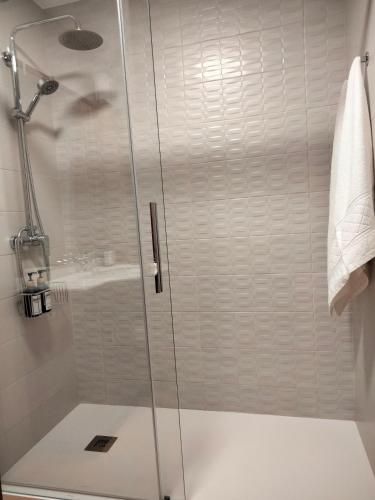 a shower with a glass door in a bathroom at ATICO CALDAS in Caldas de Reis