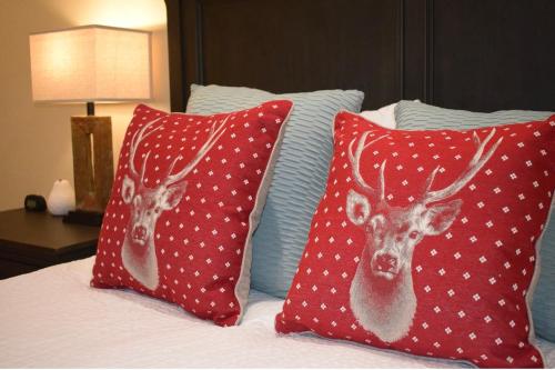 two red pillows with a deer on them on a bed at Palo Alto 1Bedroom/2 Baths Near Stanford in Palo Alto