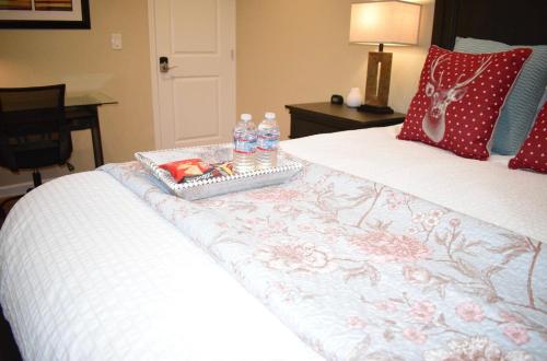 a bed with a tray of water bottles on it at Palo Alto 1Bedroom/2 Baths Near Stanford in Palo Alto