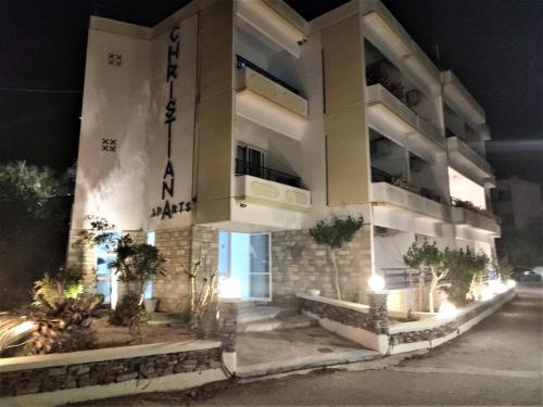 Christiana Hotel Apartments في غينادي: مبنى عليه علامة في الليل