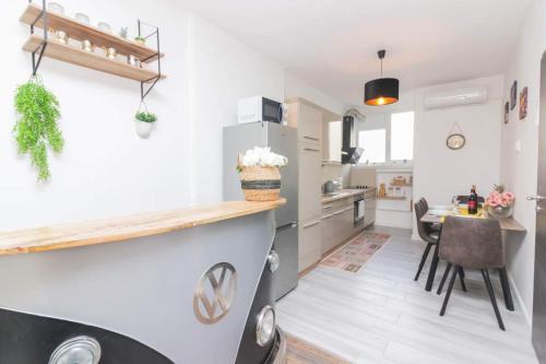 a kitchen with white walls and a counter and a table at Emily in Zadar
