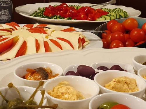 a table topped with different types of food in bowls at Der Torwirt Radstadt in Radstadt