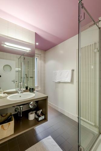 a bathroom with a sink and a shower at Boutique Hotel KARL in Luzern