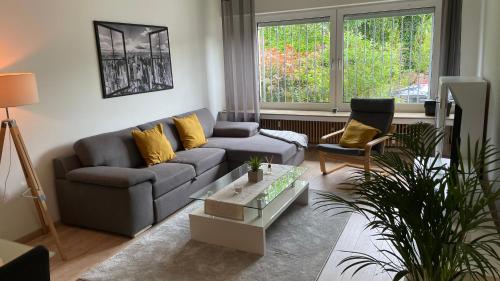 a living room with a couch and a chair at Apart70-Modern Design I Garden with Terrace I Smart TV I Free Parking I Free WiFi in Hamm