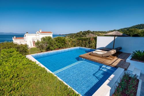 a swimming pool with a view of the ocean at Kappa Resort in Paliouri