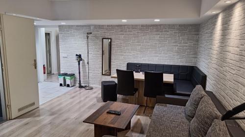 a living room with a table and a brick wall at City-Apartment Spreeufer im Herzen Berlins in Berlin