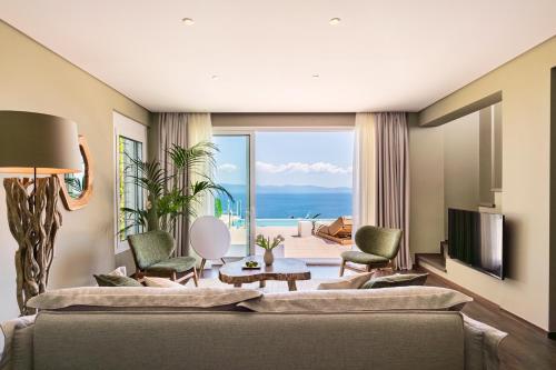 a living room with a view of the ocean at Kappa Resort in Paliouri