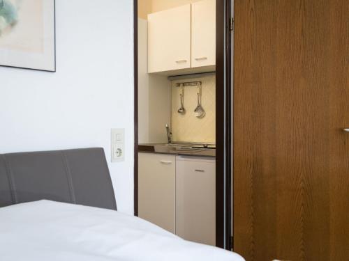 a room with a bed and a kitchen with a sink at Apartment B306 by Interhome in Lahnstein