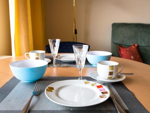 a table with plates and bowls and cups on it at Apartment B807 by Interhome in Lahnstein