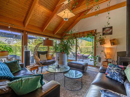 a living room with leather furniture and a wooden ceiling at Holiday Home Blue Moustoir by Interhome in Carnac