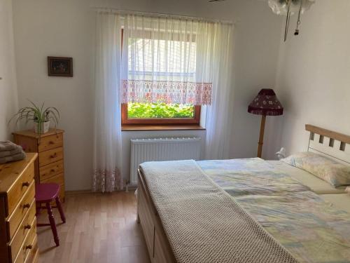 a bedroom with a bed and a window at Am Steyr-Ufer in Sierning