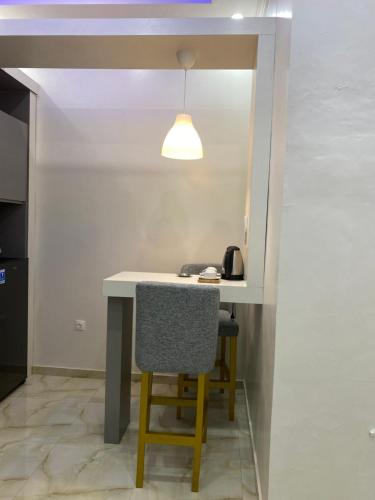 a table and a chair in a room at Algara Puncak Hotel in Puncak