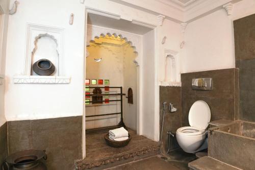 a bathroom with a toilet in a room at Madri Haveli in Udaipur