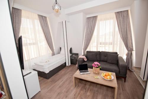 a living room with a couch and a table at СПА Хотел Романтика in Sarnitsa