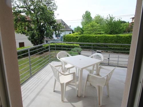 a white table and chairs on a balcony at Villa Giuseppina by Interhome in Besozzo