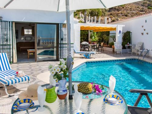 a villa with a swimming pool and a patio at Villa Las Brisas by Interhome in Nerja