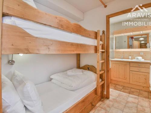 a bedroom with two bunk beds and a bathroom at Appartement Le Grand-Bornand, 2 pièces, 4 personnes - FR-1-391-110 in Le Grand-Bornand