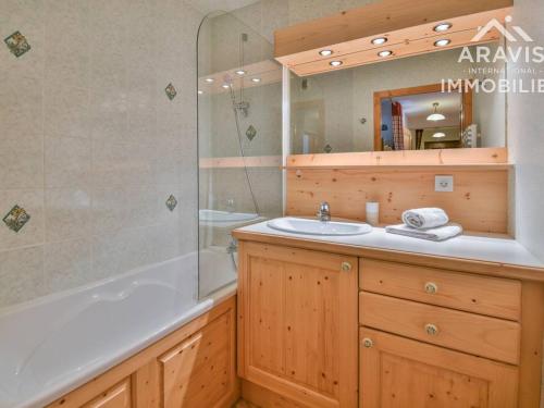 a bathroom with a sink and a shower and a tub at Appartement Le Grand-Bornand, 2 pièces, 4 personnes - FR-1-391-110 in Le Grand-Bornand