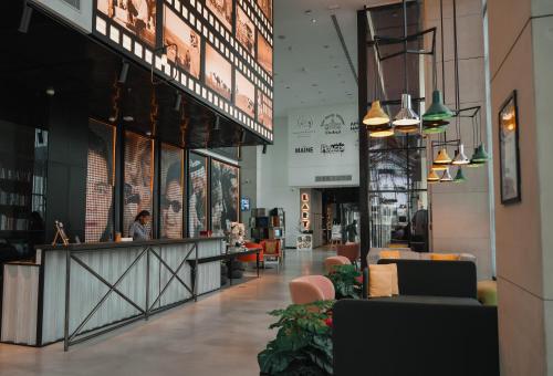 a lobby of a building with a person sitting at a counter at Studio One Hotel in Dubai