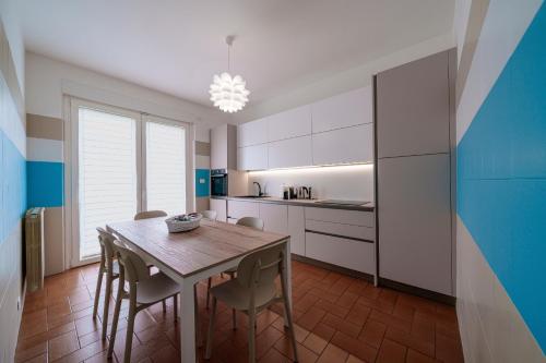 a kitchen with a table and chairs in a room at Casa Vacanza Acqua Dolce in Maccagno Inferiore