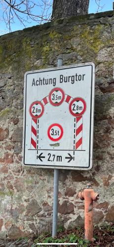 a sign for an eating burrito next to a wall at Daniels Apartment an der Schloßbrücke in Meißen