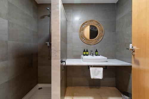a bathroom with a sink and a shower at Pont Sec Apartments in Denia