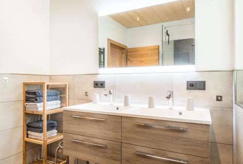 a bathroom with a sink and a mirror at Appartement Bergpanorama Brandegg in Wagrain