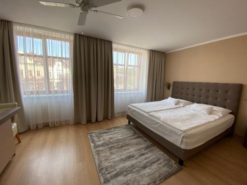 a bedroom with a large bed and a rug at Hotel MAGISTR Vsetín in Vsetín