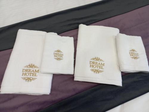 three white pillows with the dream hotel logo on them at Dream Hotel in Haghpat